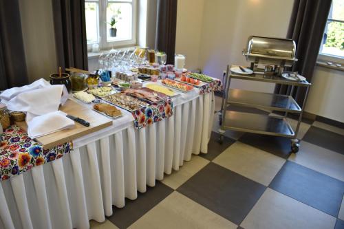 a table with a buffet of food on it at Eco Nieborów in Nieborów