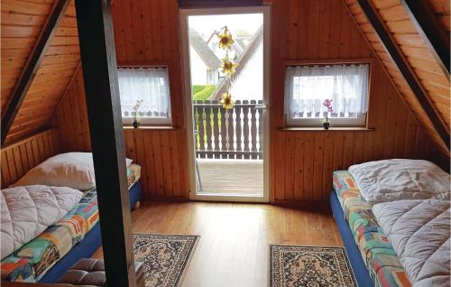 a room with two beds and two windows at Holiday Home Bootshaus Nr V in Teterow
