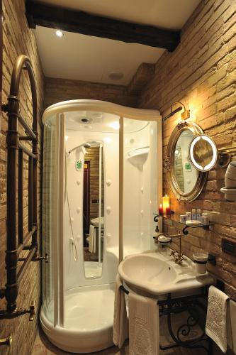 a bathroom with a white sink and a mirror at Hotel Bonconte in Urbino