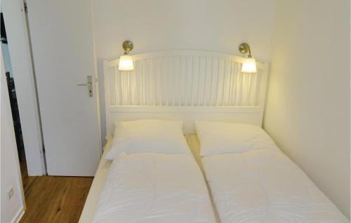 a small bedroom with a bed with white sheets at 2 Bedroom Awesome Apartment In Wismar in Wismar
