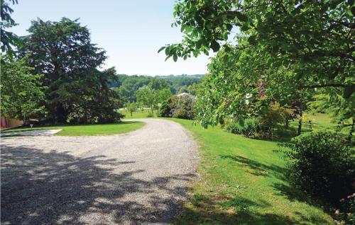 a gravel road in a park with trees and grass at Beautiful Home In Bourgougnague in Bourgougnague