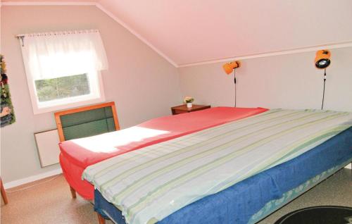 a bedroom with a bed and a window at Holiday Home Trollungebyn Dalskog in Dalskog