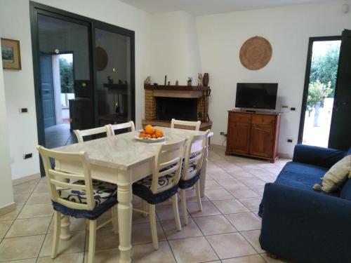 a dining room with a white table and chairs at Villa Pula Mare in Pula