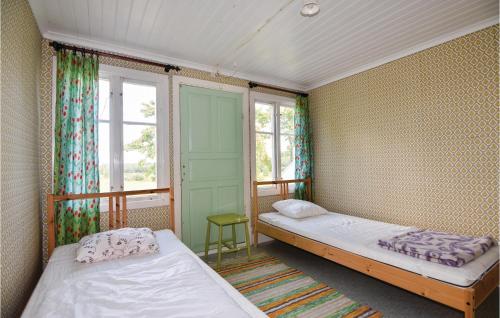 a bedroom with two beds and a window at Lovely Home In Högsäter With Kitchen in Högsäter