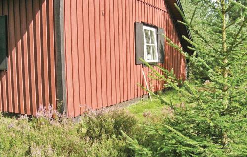 a red building with a window on the side of it at Stunning Home In Hestra With Sauna in Hestra