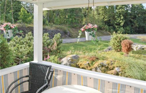 a porch with a table and a view of a garden at Holiday Home Trollungebyn Dalskog in Dalskog
