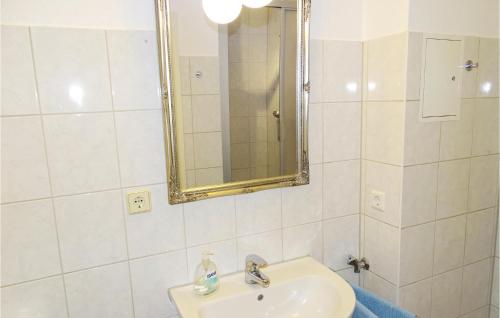 a white bathroom with a sink and a mirror at 2 Bedroom Awesome Apartment In Wismar in Wismar