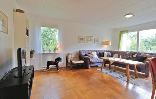 a dog standing in a living room with a couch at 3 Bedroom Gorgeous Home In Yngsjö in Yngsjö