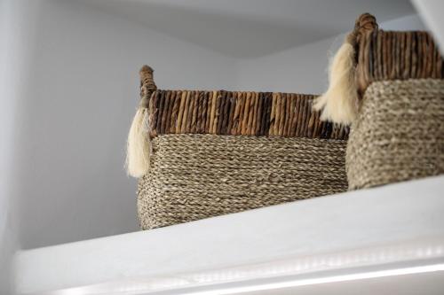 two knitted baskets sitting on top of a shelf at Majestique of Naxos luxury suites in Naxos Chora