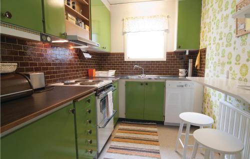 a kitchen with green cabinets and a sink at Awesome Home In Lrbro With 1 Bedrooms in Ire