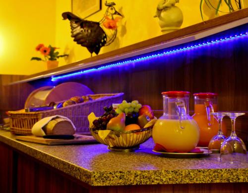 a table with a bowl of fruit and a drink at Hotel St Georg - Regensburg in Regensburg