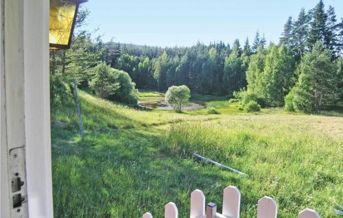 a view of a field from a house with a fence at Holiday Home Ljungkullen Ramkvilla in Ramkvilla