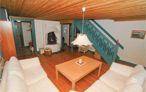 a living room with a couch and a table at Two-Bedroom Holiday Home In Mullsjo in Mullsjö