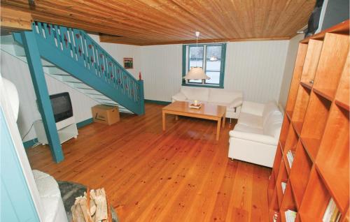 a living room with a couch and a table at Two-Bedroom Holiday Home In Mullsjo in Mullsjö