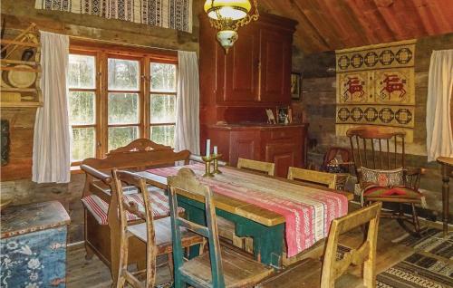 a dining room with a table and some chairs at Two-Bedroom Holiday Home In Vittsjo in Vittsjö