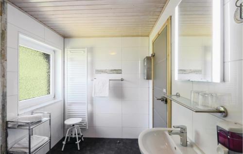 a white bathroom with a sink and a mirror at Ferienhaus 4 In Thalfang in Thalfang