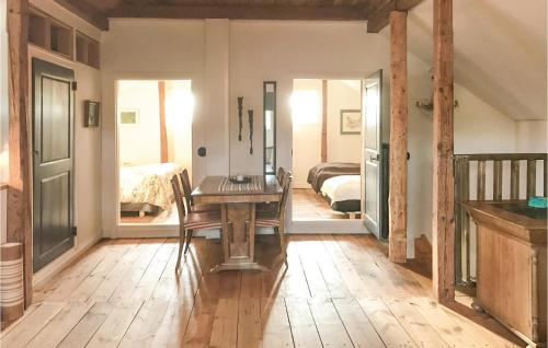 a room with a wooden table and a bedroom at 2 Bedroom Beautiful Home In Rimforsa in Skälhamra