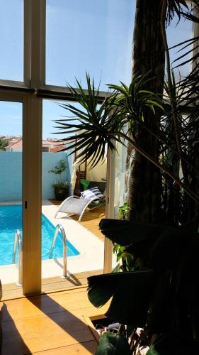 a view of a swimming pool from a house at PH in Atlantic Coast in Charneca