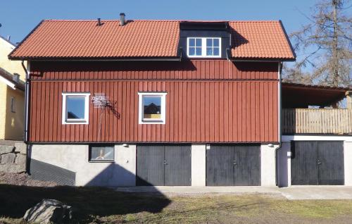 a house with a red roof and a fence at 2 Bedroom Beautiful Home In Rimforsa in Skälhamra