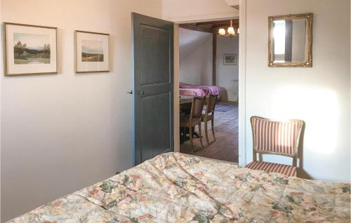 a bedroom with a bed and a table and chairs at 2 Bedroom Beautiful Home In Rimforsa in Skälhamra