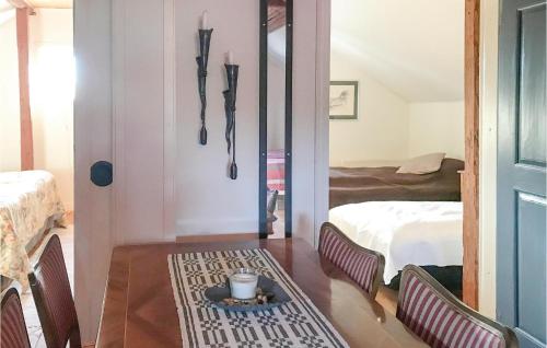 a room with a room with a bed and a table at 2 Bedroom Beautiful Home In Rimforsa in Skälhamra
