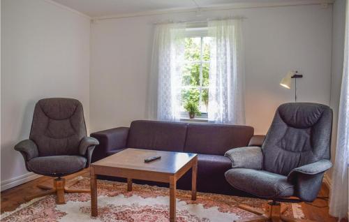 a living room with a couch and two chairs and a table at One-Bedroom Holiday Home In Gullabo in Gullabo