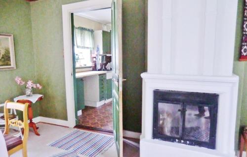 a living room with a fireplace and a mirror at Holiday Home Mariannelund Kyrkoryd Kråkstorp in Svenstorp