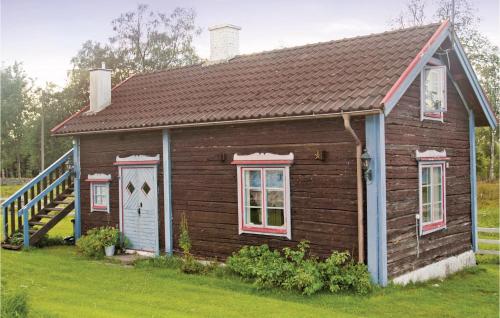a small house with a brown roof at Two-Bedroom Holiday Home In Mullsjo in Mullsjö