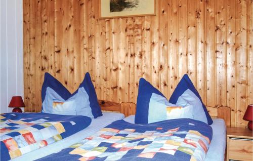 a bedroom with two beds with blue pillows at Beautiful Home In Usedom With Kitchen in Wilhelmshof