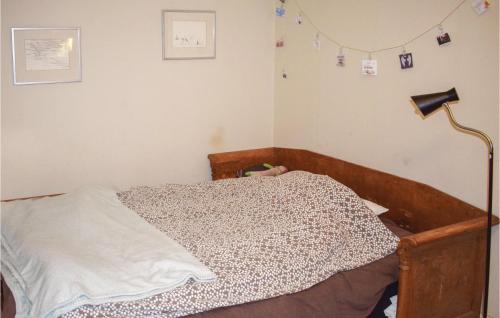 a bedroom with a bed and a lamp and decorations at 3 Bedroom Nice Apartment In Vimmerby in Vimmerby