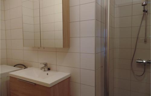 a bathroom with a sink and a shower at Cozy Home In Engerdal With House A Mountain View in Femundsundet