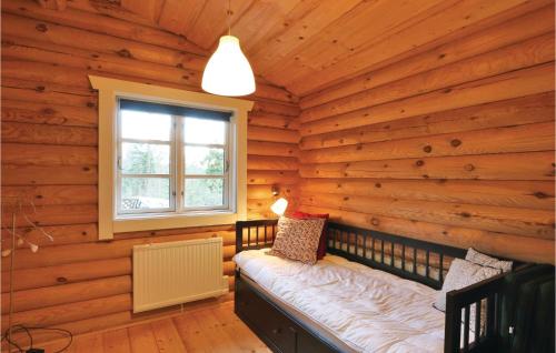a log cabin with a bench in a window at Nice Home In Gnosj With Sauna in Gnosjö