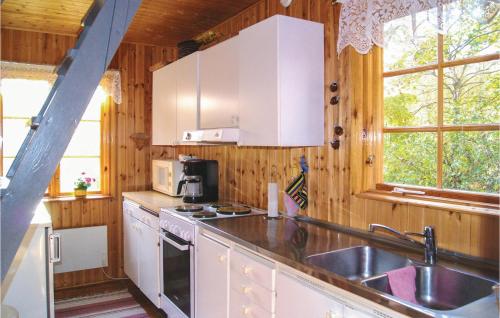 uma cozinha com um lavatório e um fogão forno superior em 3 Bedroom Stunning Home In Ystad em Ystad