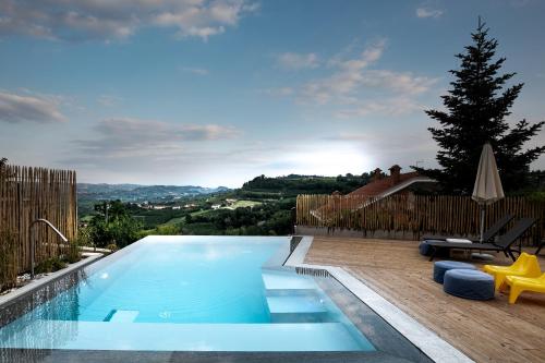 a swimming pool with a view of a house at Cà del Re in Verduno