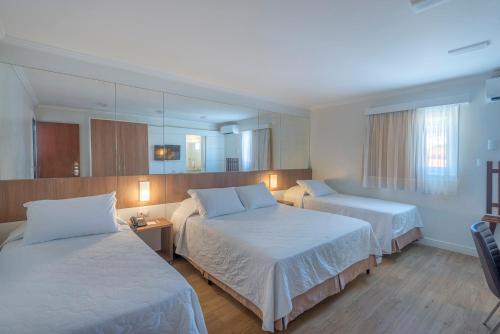 Ένα ή περισσότερα κρεβάτια σε δωμάτιο στο Hotel Glória Blumenau