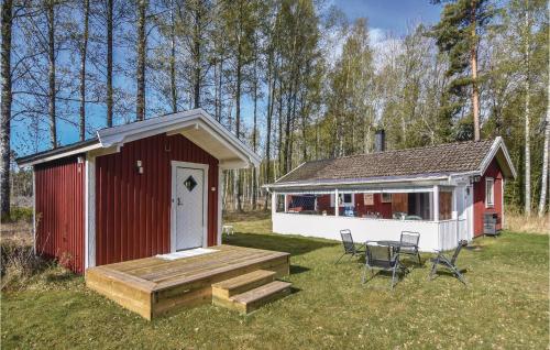 a small red and white shed with a table and chairs at Holiday Home Geterud Hammarö in Hammarö
