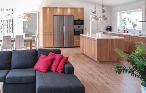 a living room with a couch and a kitchen at Three-Bedroom Holiday Home In Kopingsvik in Köpingsvik