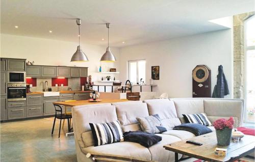 a living room with a couch and a kitchen at Nice Home In Narbonne With Sauna in Narbonne
