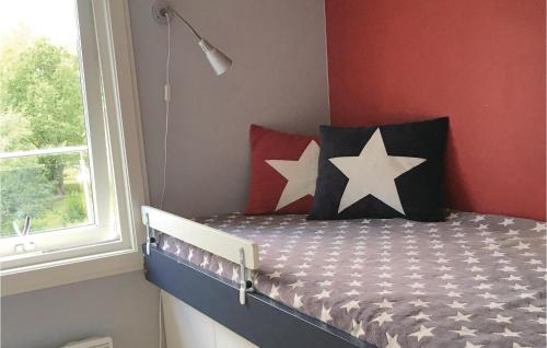 a bedroom with a bed with stars on it at 4 Bedroom Gorgeous Home In Boxholm in Blåvik