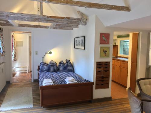 a bedroom with a bed with blue pillows at Haus Honigstal Landhaus Café in Wuppertal