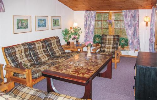 a living room with a couch and a coffee table at Three-Bedroom Holiday Home In Ystad in Ystad