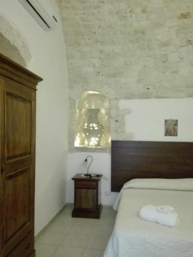 a bedroom with a bed and a lamp on a table at B&B Villa Rosanna in Fasano
