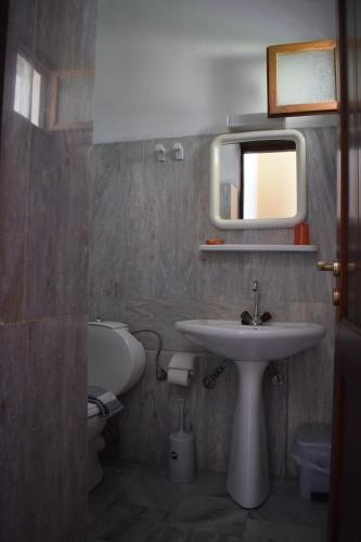 a bathroom with a sink and a mirror at Porto Galini in Agia Galini