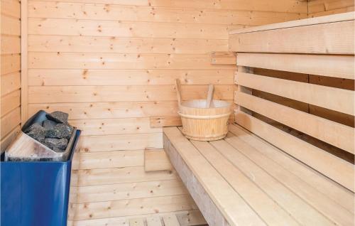 a wooden sauna with a bucket and a trash can at 4 Bedroom Gorgeous Home In Boxholm in Blåvik