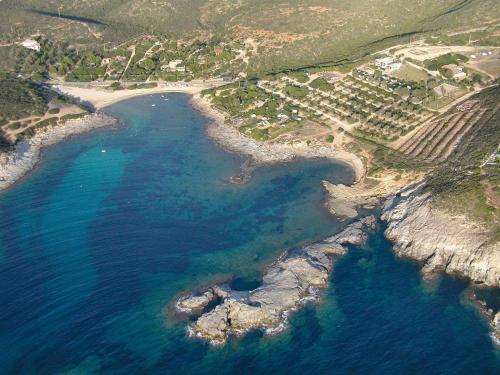an aerial view of a beach and the ocean at Hotel Perda Rubia in San Giovanni Suèrgiu