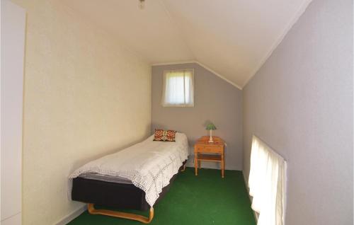 a bedroom with a bed and a table with a window at Gorgeous Home In Åmål With Wifi in Åmål
