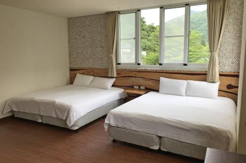 Katil atau katil-katil dalam bilik di Chihpen Lucky Hot Spring B&B