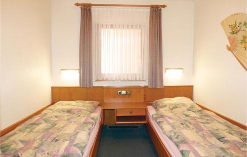 a room with two beds and a desk and a window at Ferienhaus 22 In Thalfang in Thalfang