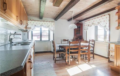 a kitchen with a table and chairs and a dining room at Lovely Apartment In Havdhem With Wifi in Havdhem