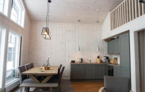 a kitchen with a wooden table and a dining room at Cozy Home In Lillehammer With Wifi in Lillehammer
